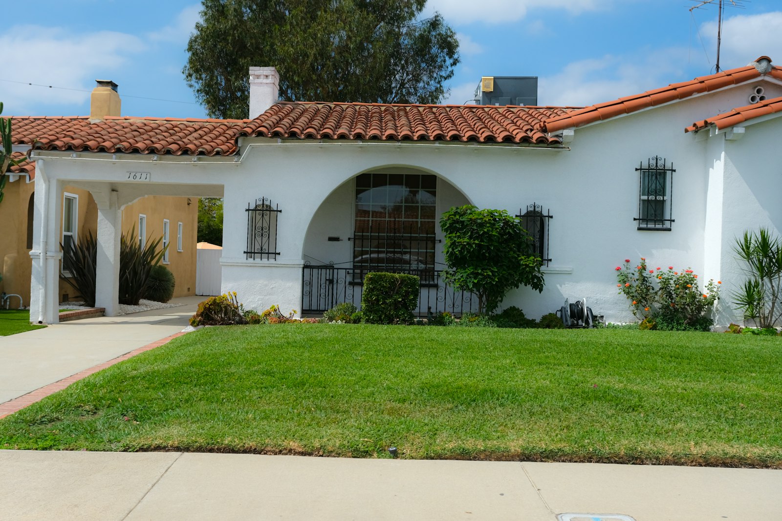 Tile-roof Mesa home with maintained desert yard, trimmed shrubs, and clean granite borders.